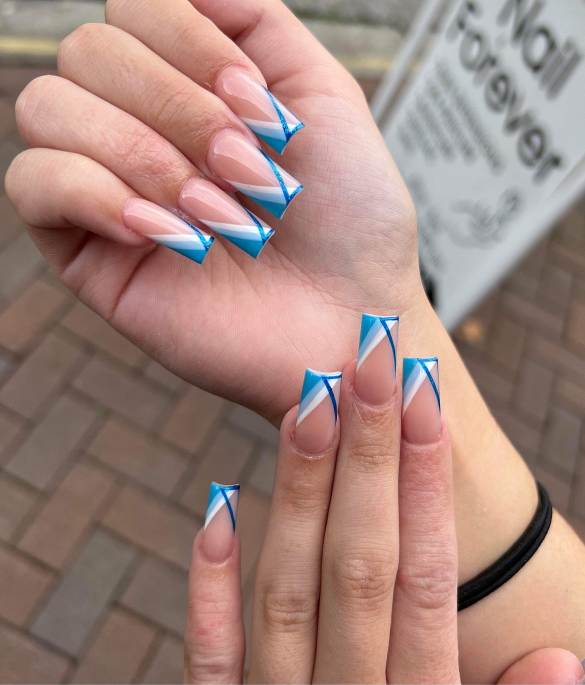 Blue diagonal French tip nails