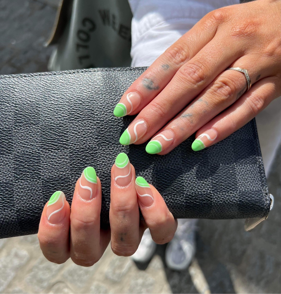 Delicate green and white swirl nails
